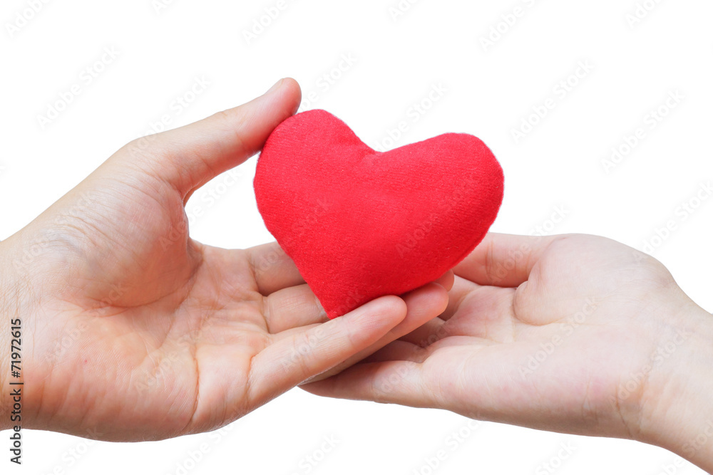 male hand giving a red heart to a female hand