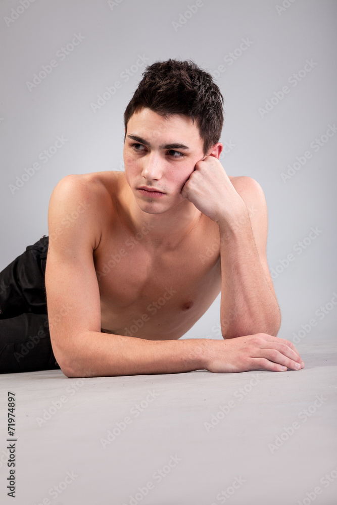 Healthy muscular young man on grey background Healthy muscular young man on grey background