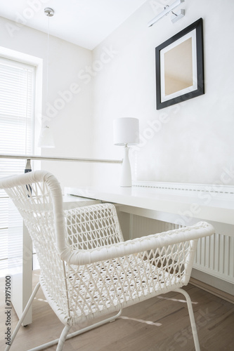 Interior with white wicker chair