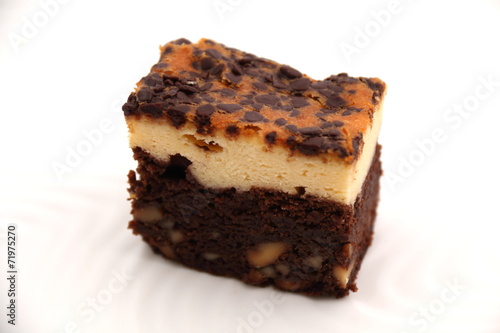 Brownie Cheese cake on a white plate.