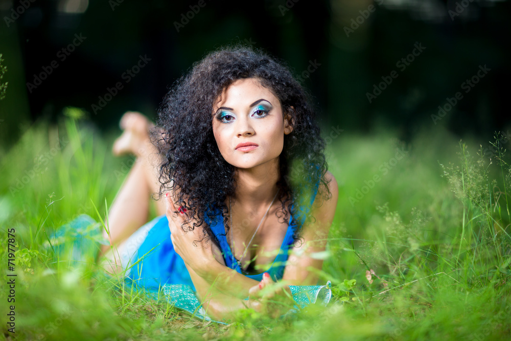Young relaxing female lying on her stomach in the grass Young relaxing female lying on her stomach in the grass
