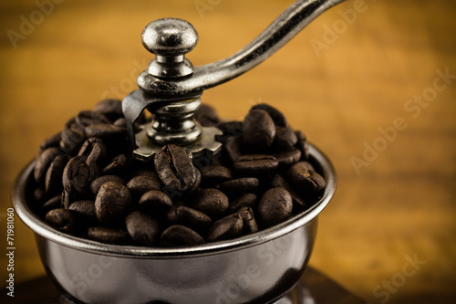 Vintage coffee grinder with coffee beans.