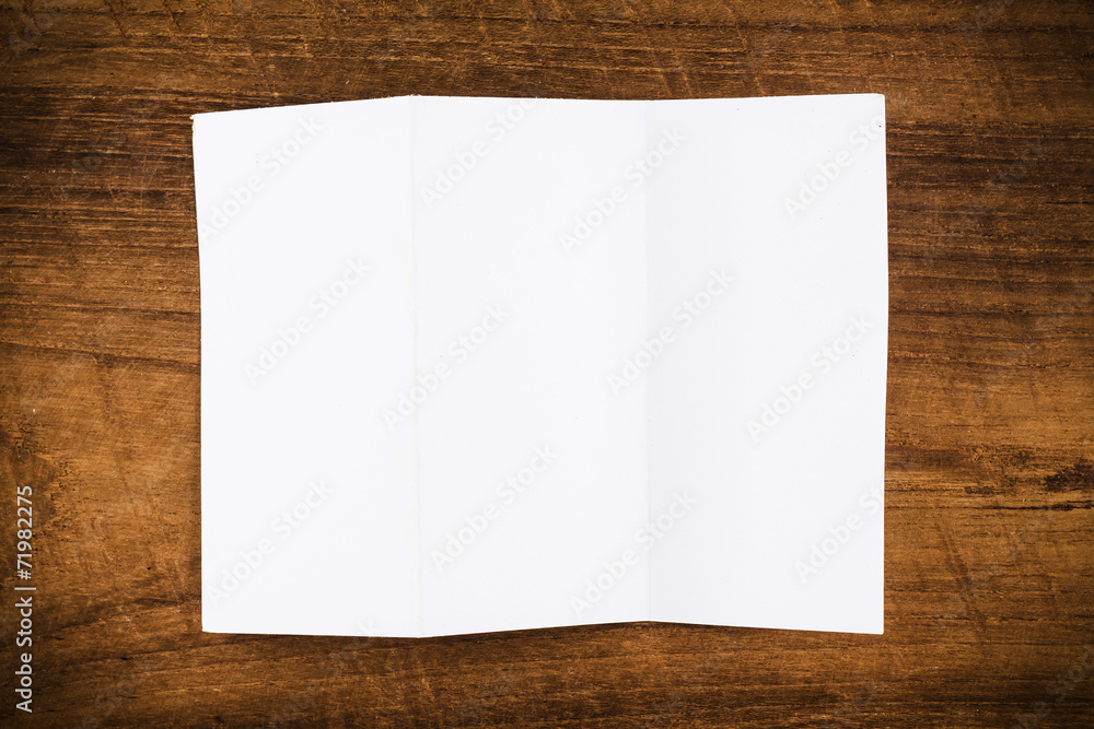 Fold paper on wood background Fold paper on wood background
