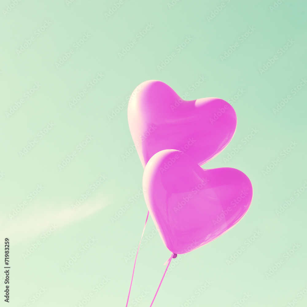 Two purple heart-shaped balloons
