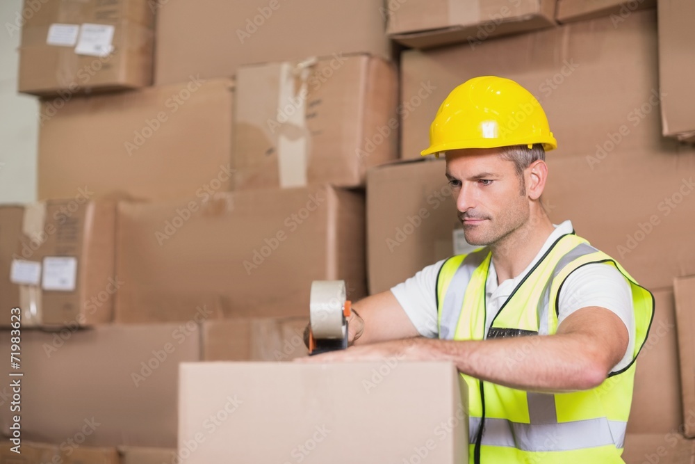 Worker preparing goods for dispatch Worker preparing goods for dispatch