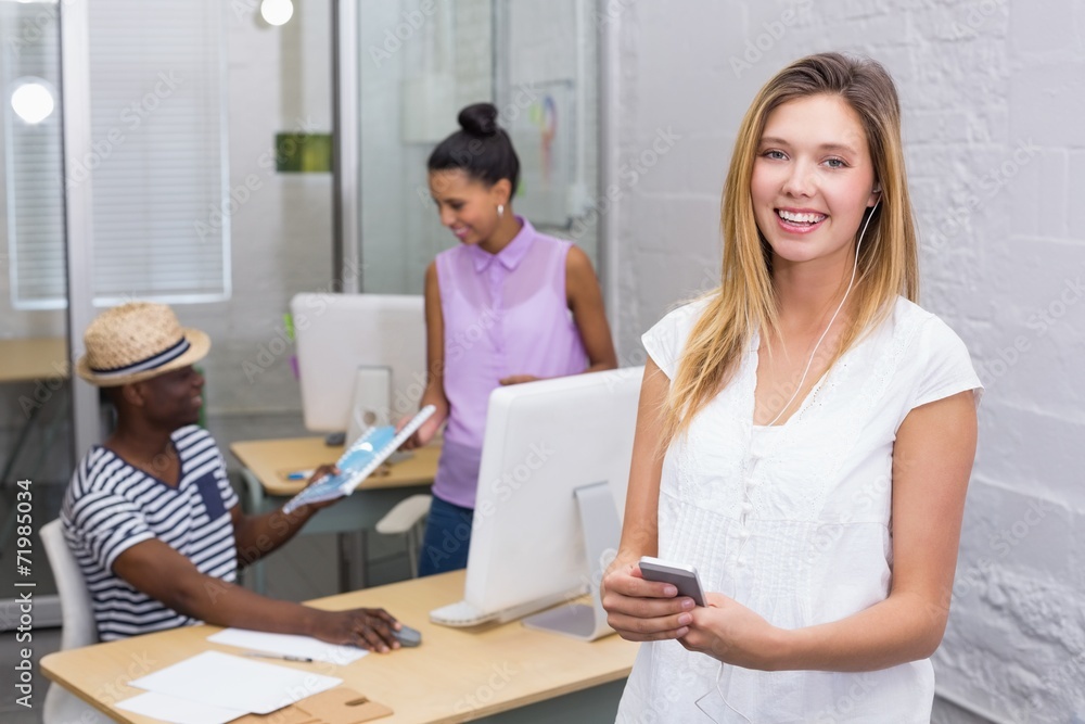 Casual woman with colleagues behind in office Casual woman with colleagues behind in office