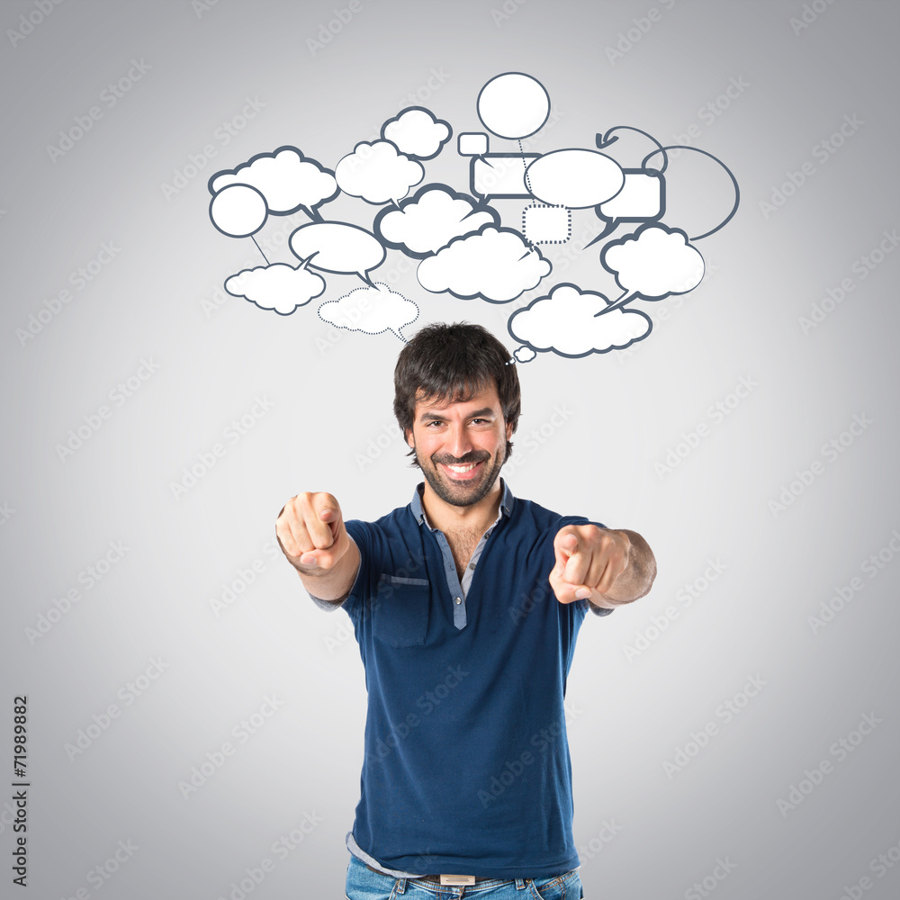 Man pointing to the front over grey background Man pointing to the front over grey background