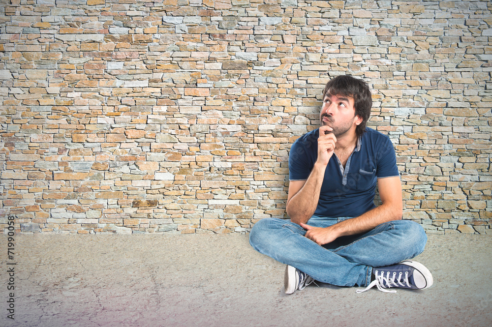 Man thinking over textured background Man thinking over textured background
