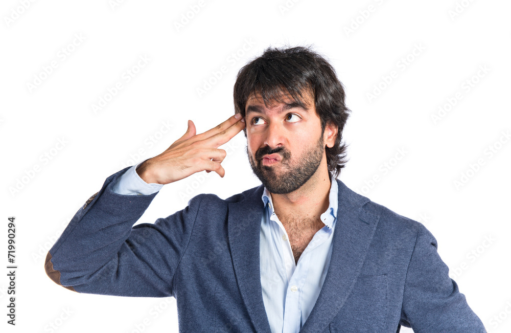 Handsome man making suicide gesture over white background Handsome man making suicide gesture over white background