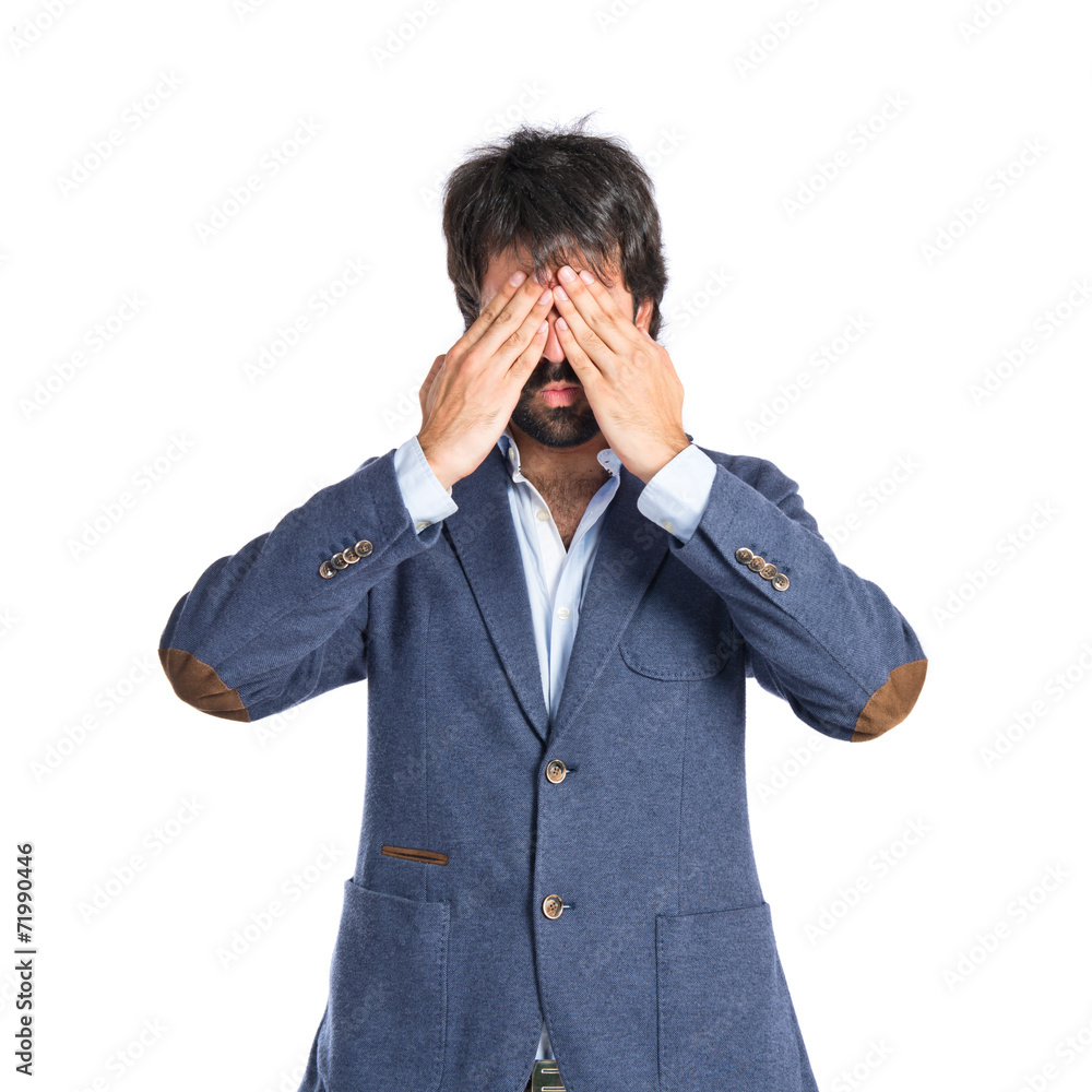 Man covering her/his eyes over isolated white background Man covering her/his eyes over isolated white background