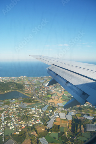 Looking village and sea through the plane window