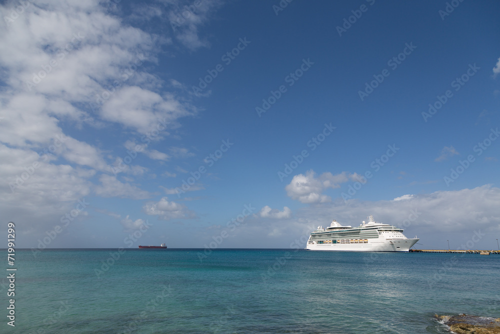 White Cruise Ship Between Blue Sky and Blue Bay White Cruise Ship Between Blue Sky and Blue Bay