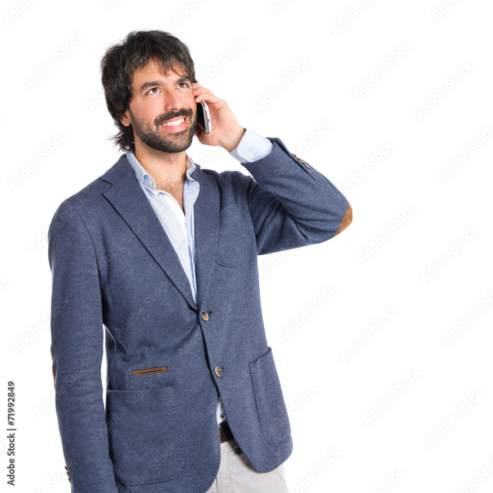 Handsome man talking to mobile over white background Handsome man talking to mobile over white background
