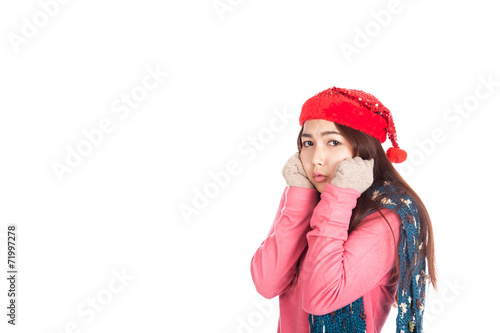 Asian girl with red christmas hat feel cold