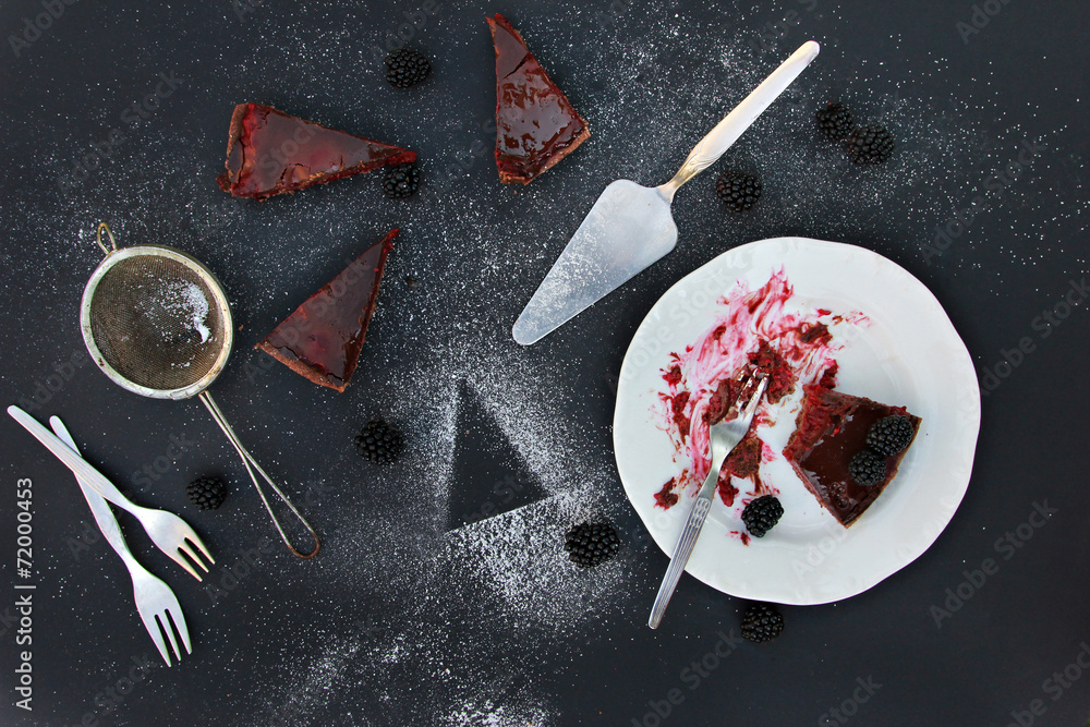 Few pieces of  blackberries tart on the black background