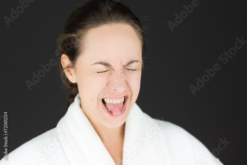 model isolated on plain background face sticking tongue out