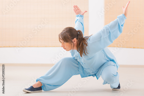 Woman doing qi gong tai chi exercise