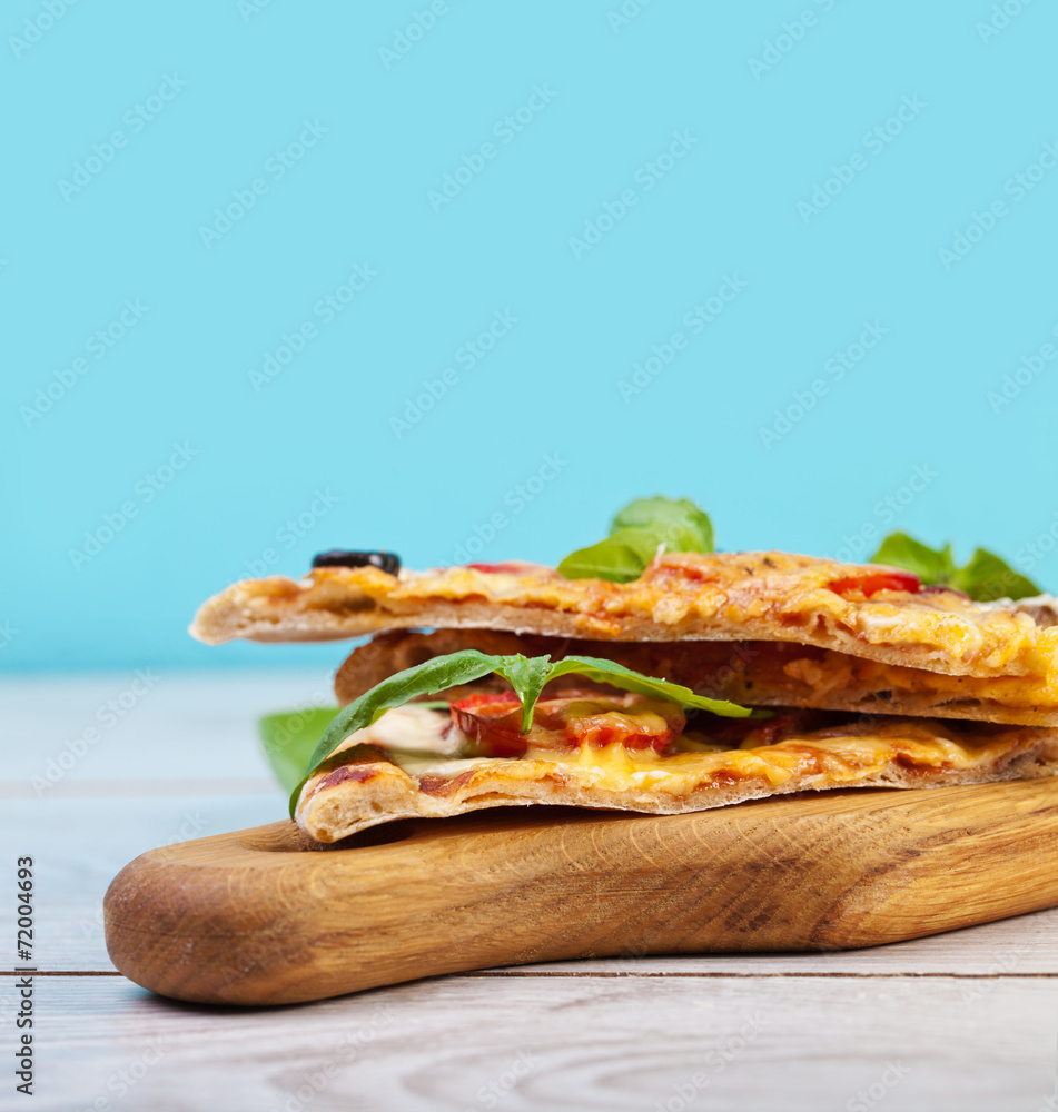 Delicious fresh pizza served on wooden table Delicious fresh pizza served on wooden table