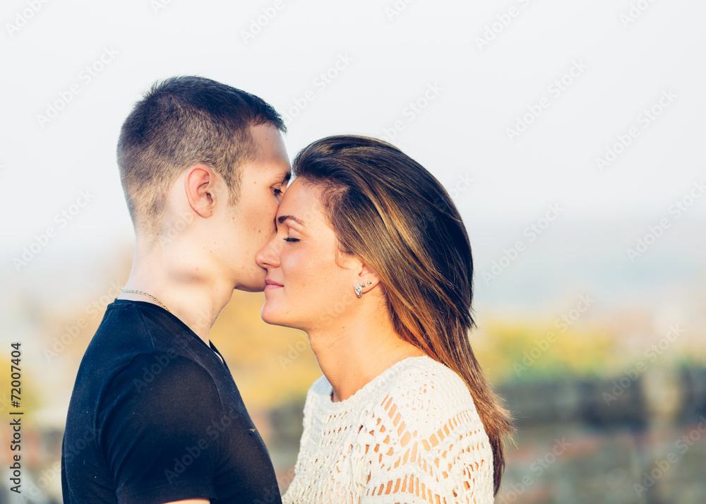 Young happy couple posing outdoor. Autumn scenery. Young happy couple posing outdoor. Autumn scenery.