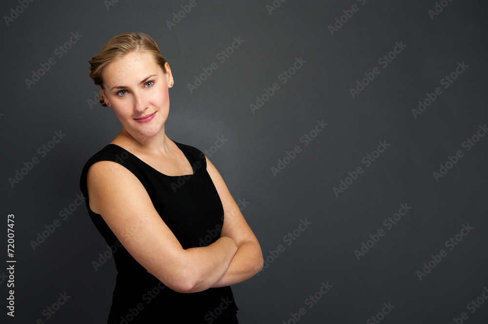 Portrait of a beautiful young business woman standing against gr Portrait of a beautiful young business woman standing against gr