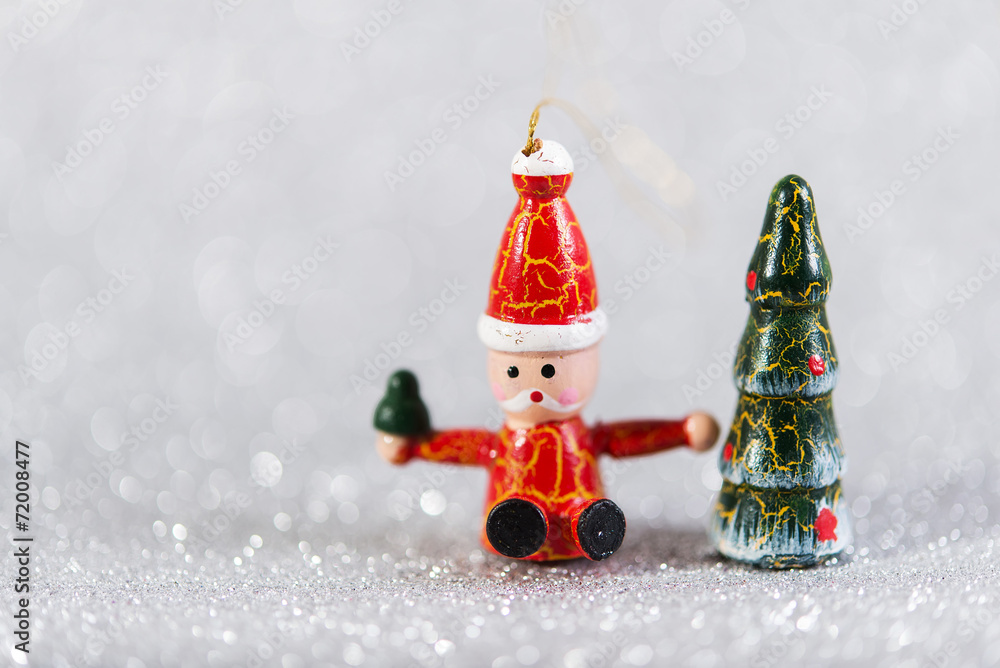 xmas decor. wooden vintage toys santa claus and christmas tree. Christmas decoration on silver glitter blur background
