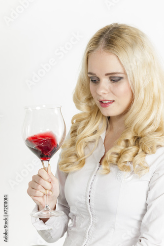 portrait of young woman with a glass of red wine
