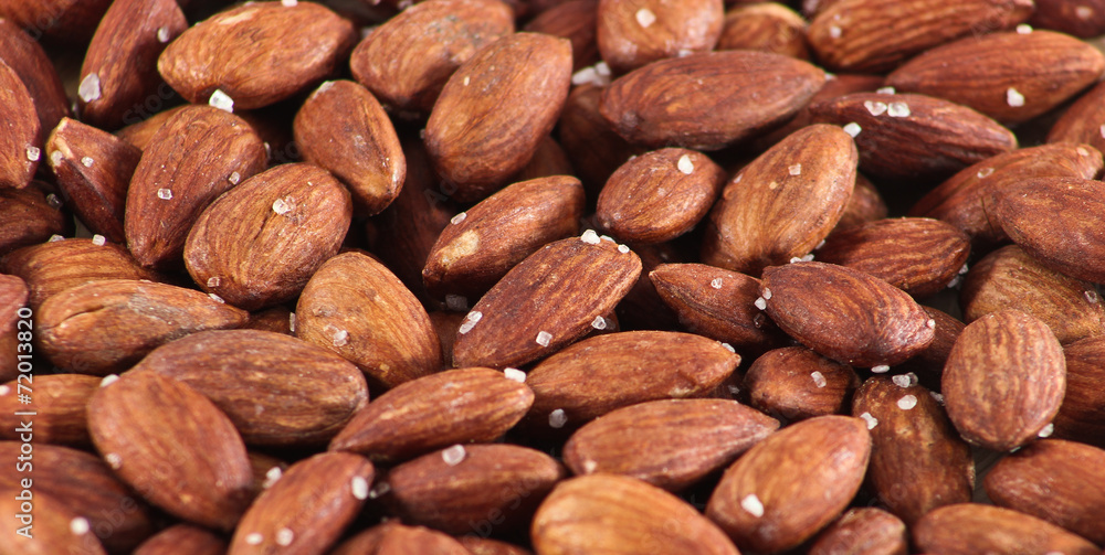 Salted Roasted Almonds Nuts on Wooden Surface Salted Roasted Almonds Nuts on Wooden Surface