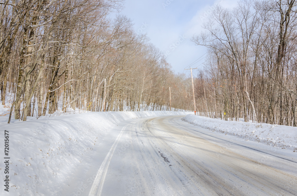 Curving Winter Road Through a Forest Curving Winter Road Through a Forest