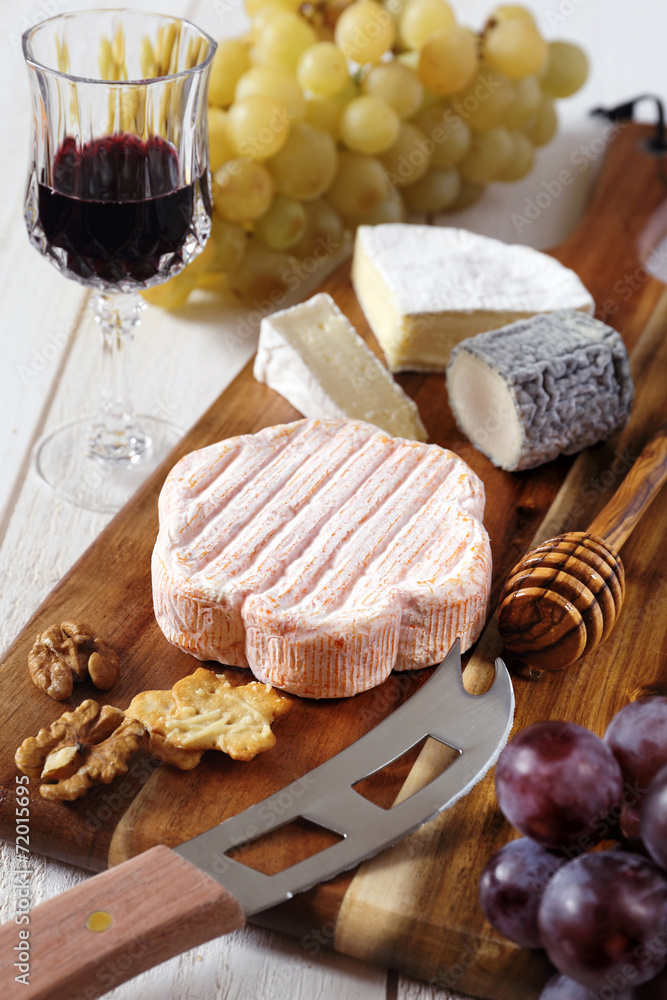 Cheese plate: French soft cheese, grapes and a glass of red wine Cheese plate: French soft cheese, grapes and a glass of red wine