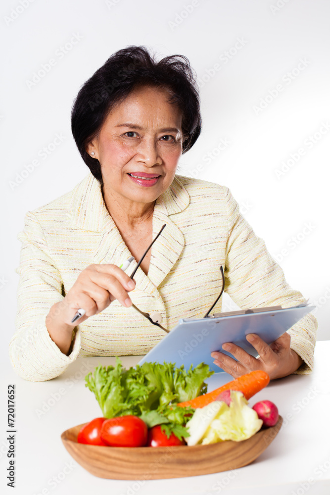 Nutritionist, Female Nutritionist act with a bowl of vegetable Nutritionist, Female Nutritionist act with a bowl of vegetable