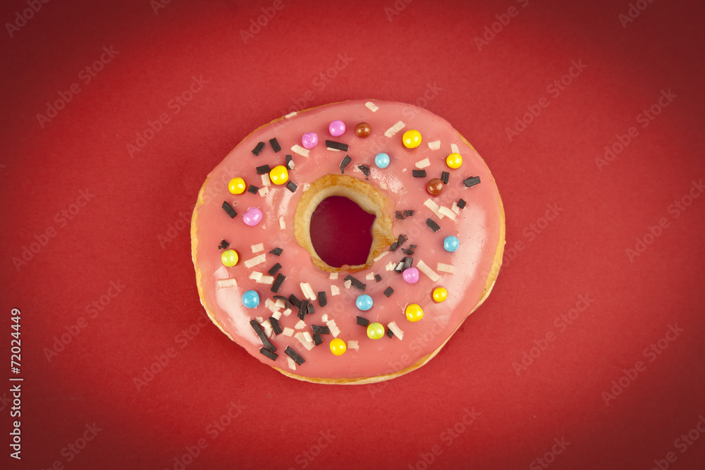 Donut with Pink and Yellow on Red Background