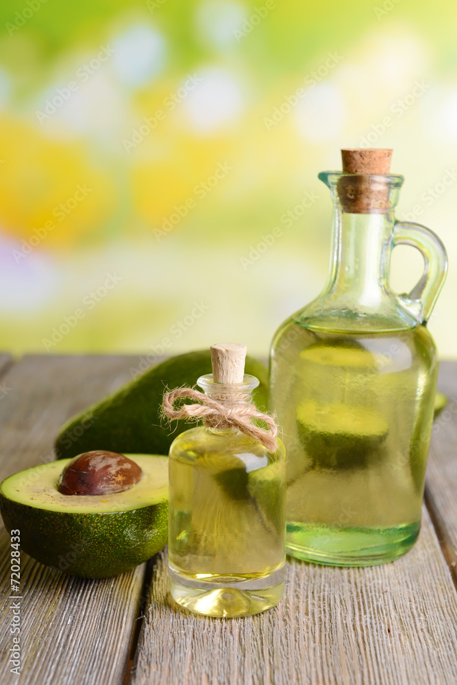 Avocado oil on table on light background Avocado oil on table on light background
