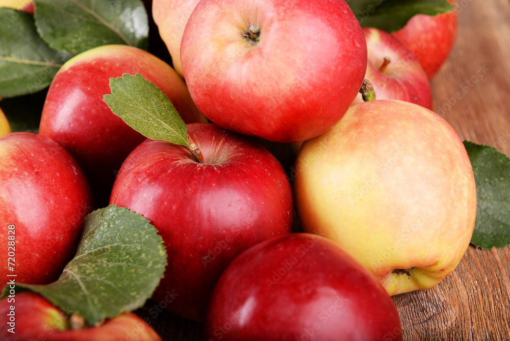 Ripe red apples on wooden background