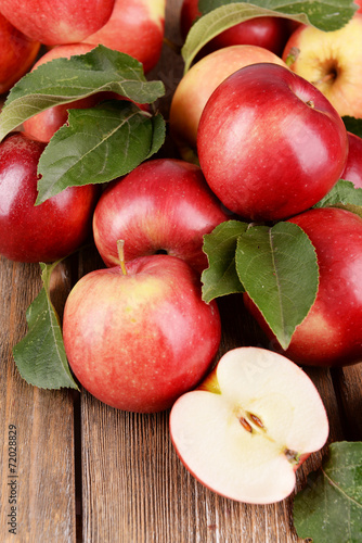 Ripe red apples on wooden background