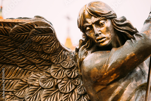 Statue Of Archangel Michael With Outstretched Wings Before Red C
