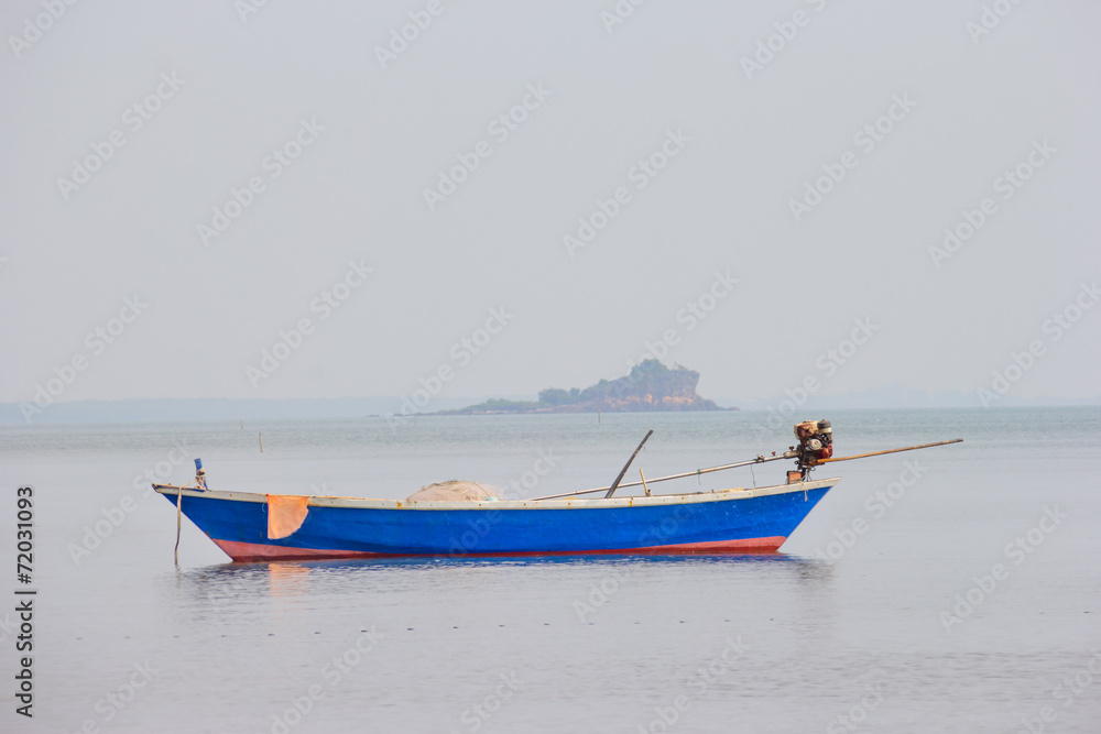 blue fishing boat on sea