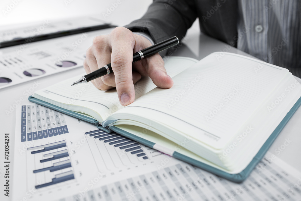 Businessman analyzing investment charts. Accounting Businessman analyzing investment charts. Accounting