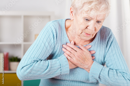 Elderly woman having heart attack
