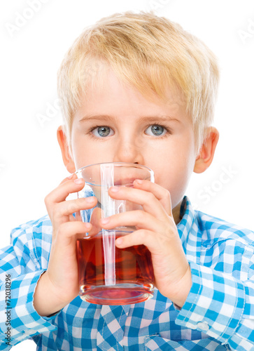 Little boy with glass of cherry juice