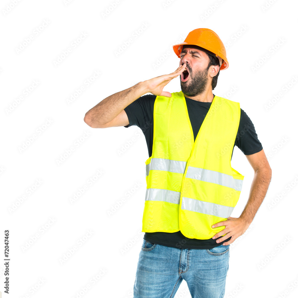 Workman yawning over isolated white background Workman yawning over isolated white background