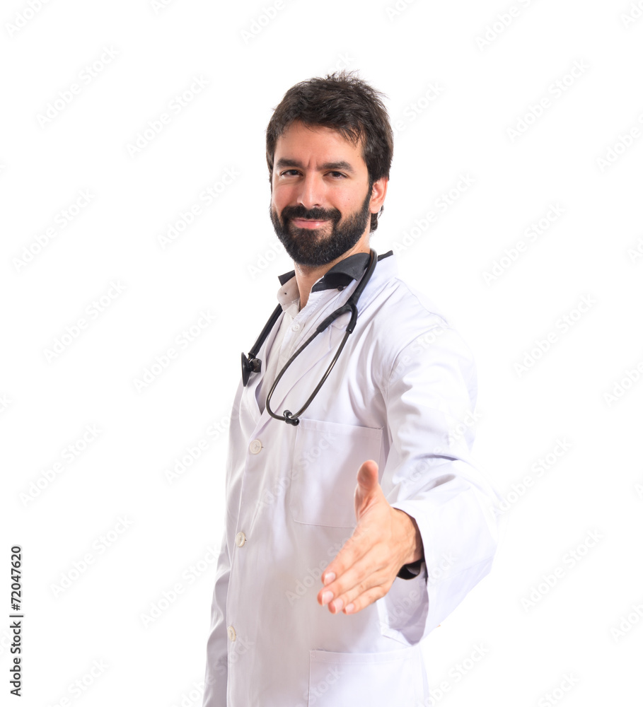 Doctor making a deal over isolated white background Doctor making a deal over isolated white background