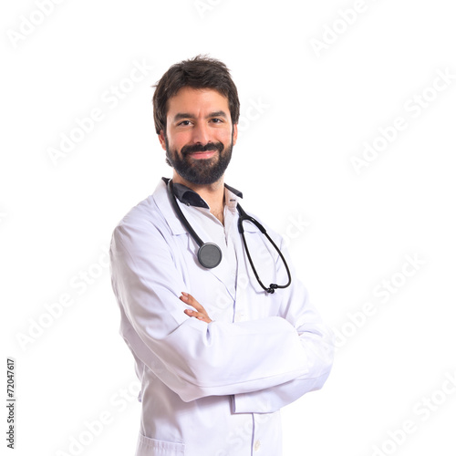 Doctor with his arms crossed over white background © luismolinero
