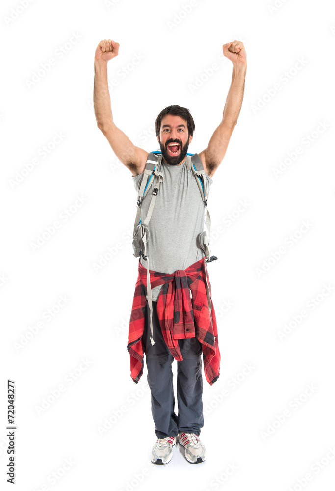 Lucky backpacker over isolated white background Lucky backpacker over isolated white background