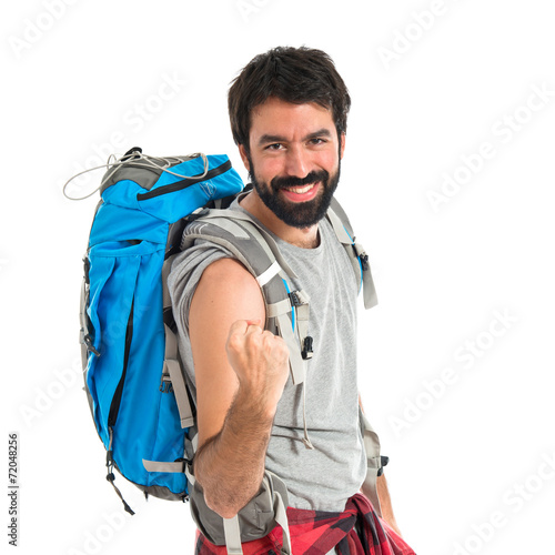 Lucky backpacker over isolated white background