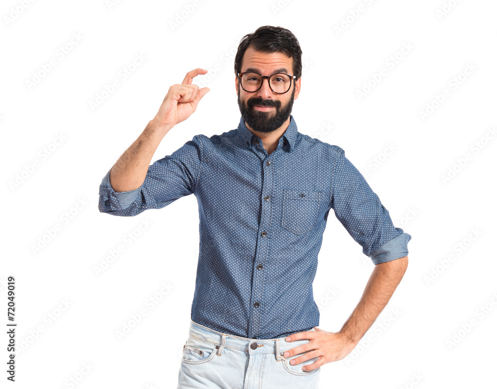 Young hipster man doing tiny sign Young hipster man doing tiny sign