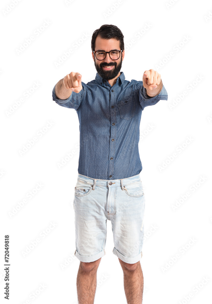 Young hipster man pointing to the front Young hipster man pointing to the front