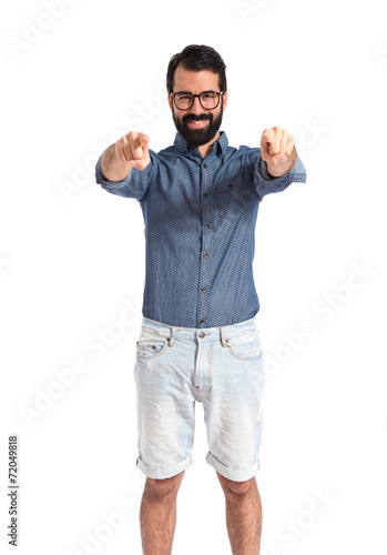 Young hipster man pointing to the front