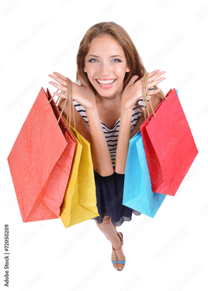Beautiful young woman with shopping bags isolated on white Beautiful young woman with shopping bags isolated on white