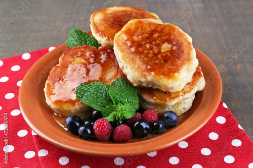 Tasty pancakes with fresh berries, honey and mint leaf