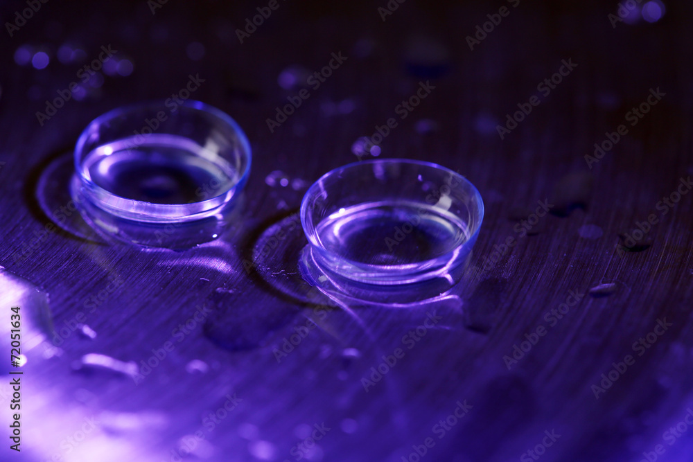 Contact lenses with water drops on bright background Contact lenses with water drops on bright background